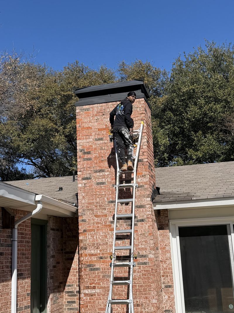An ALC technician climbing a ladder to reach a tall brick chimney stack for masonry repair