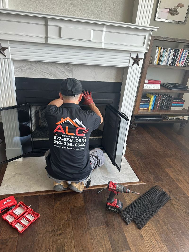 An ALC technician servicing a fireplace inside a customer's living room